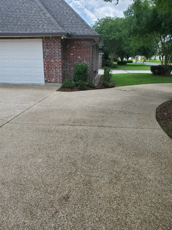 A clean concrete driveway after Delta Exterior Washing